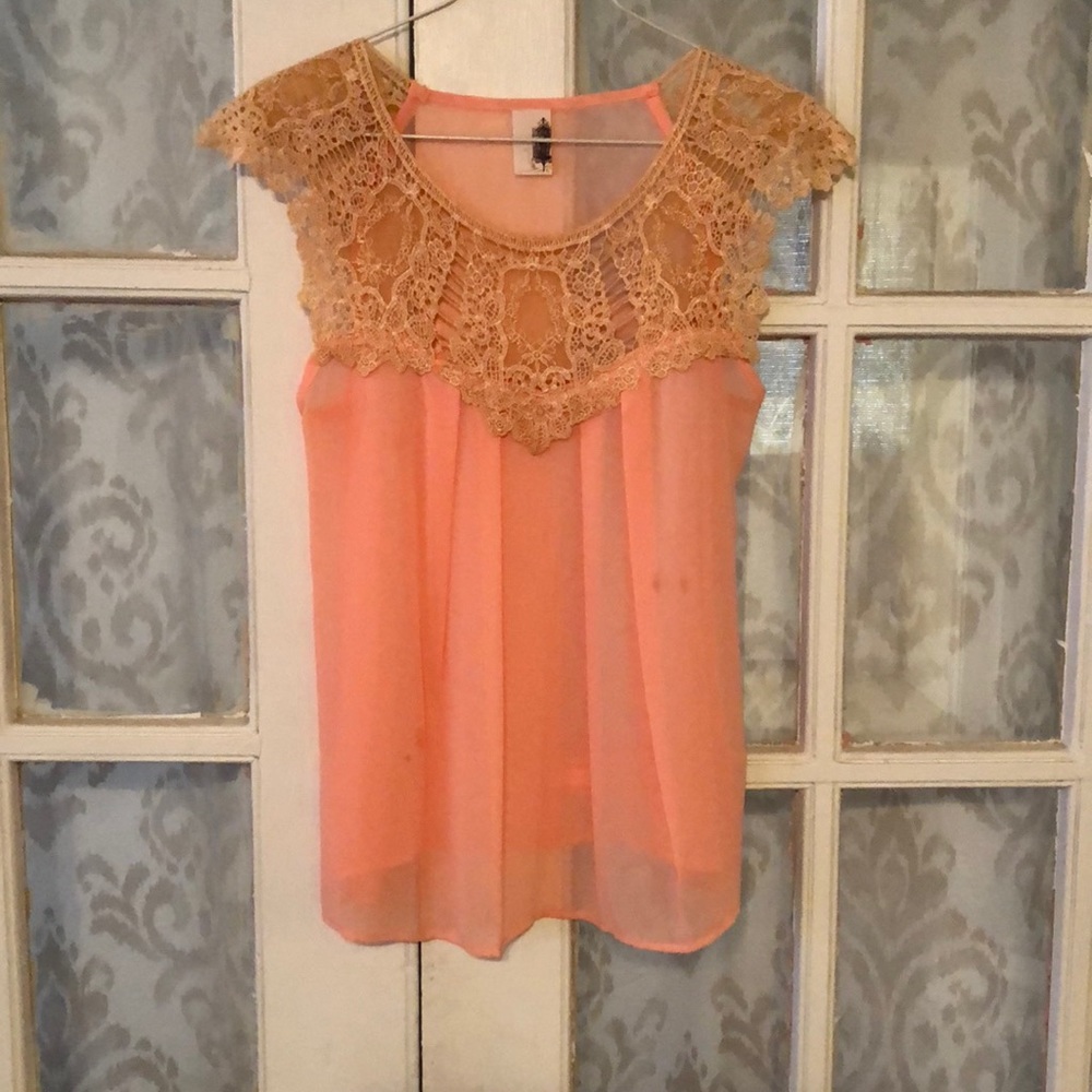Light pink top with crochet detail.